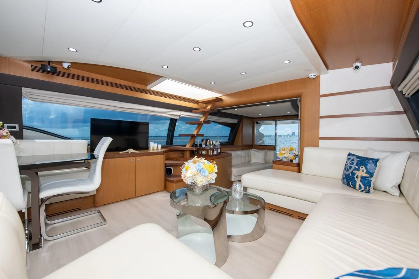 a room with a table and couch aboard HOPE Yacht for Sale