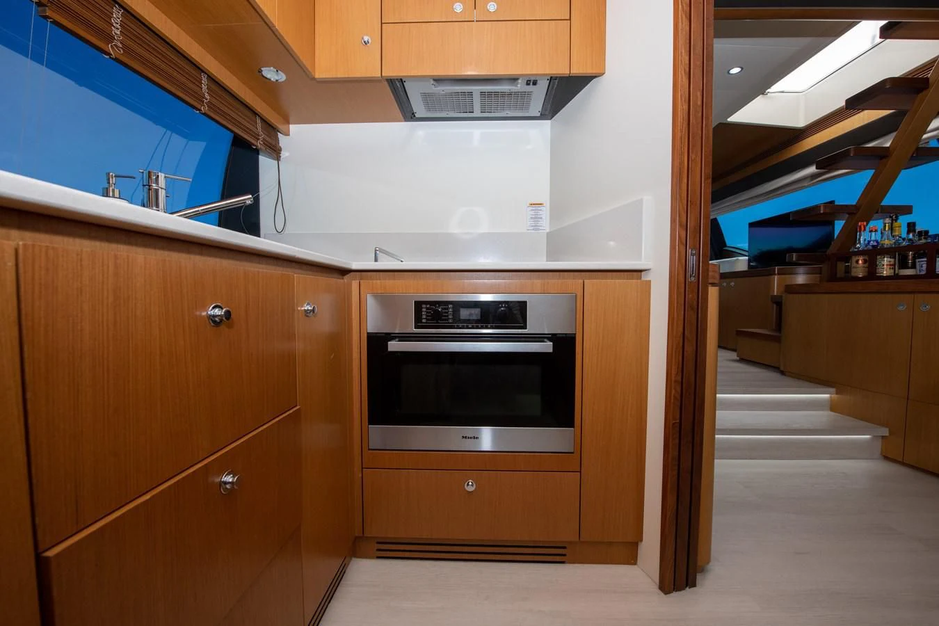 a kitchen with wooden cabinets aboard HOPE Yacht for Sale
