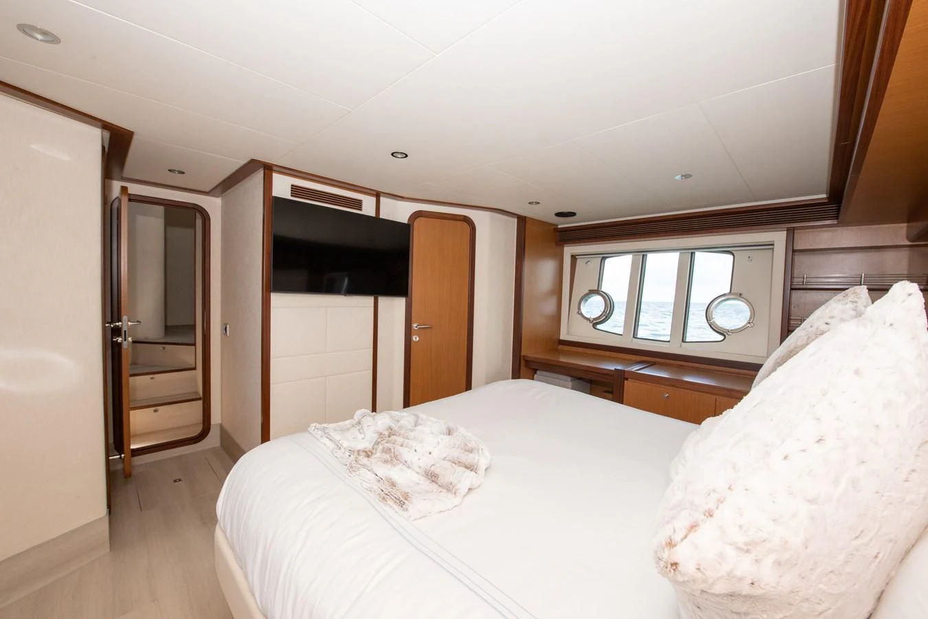 a bedroom with a bed and a closet aboard HOPE Yacht for Sale