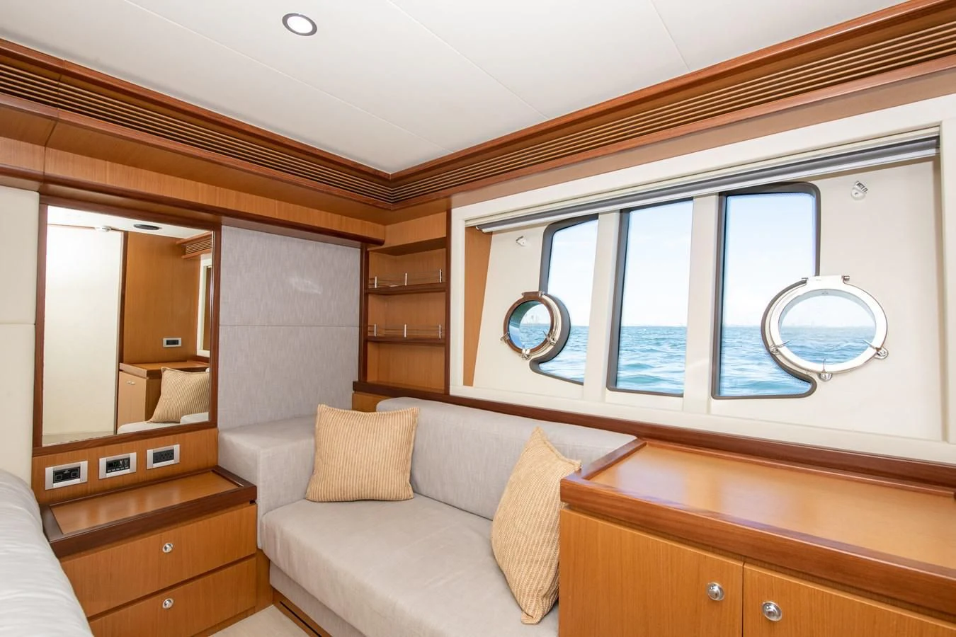 a room with a couch and a mirror aboard HOPE Yacht for Sale
