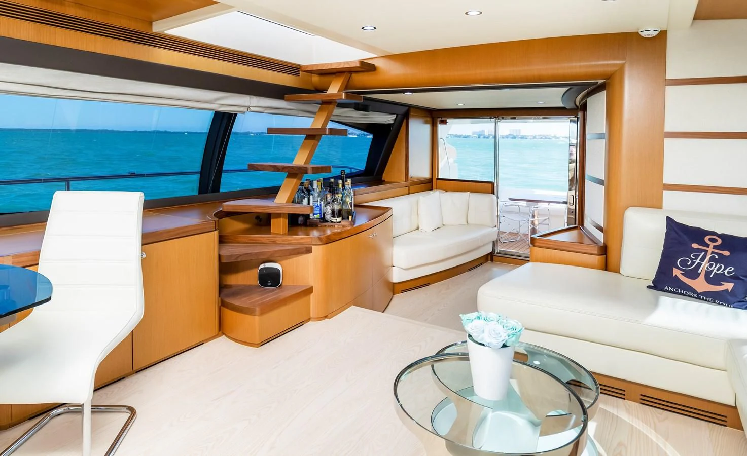 a room with a table and couches aboard HOPE Yacht for Sale