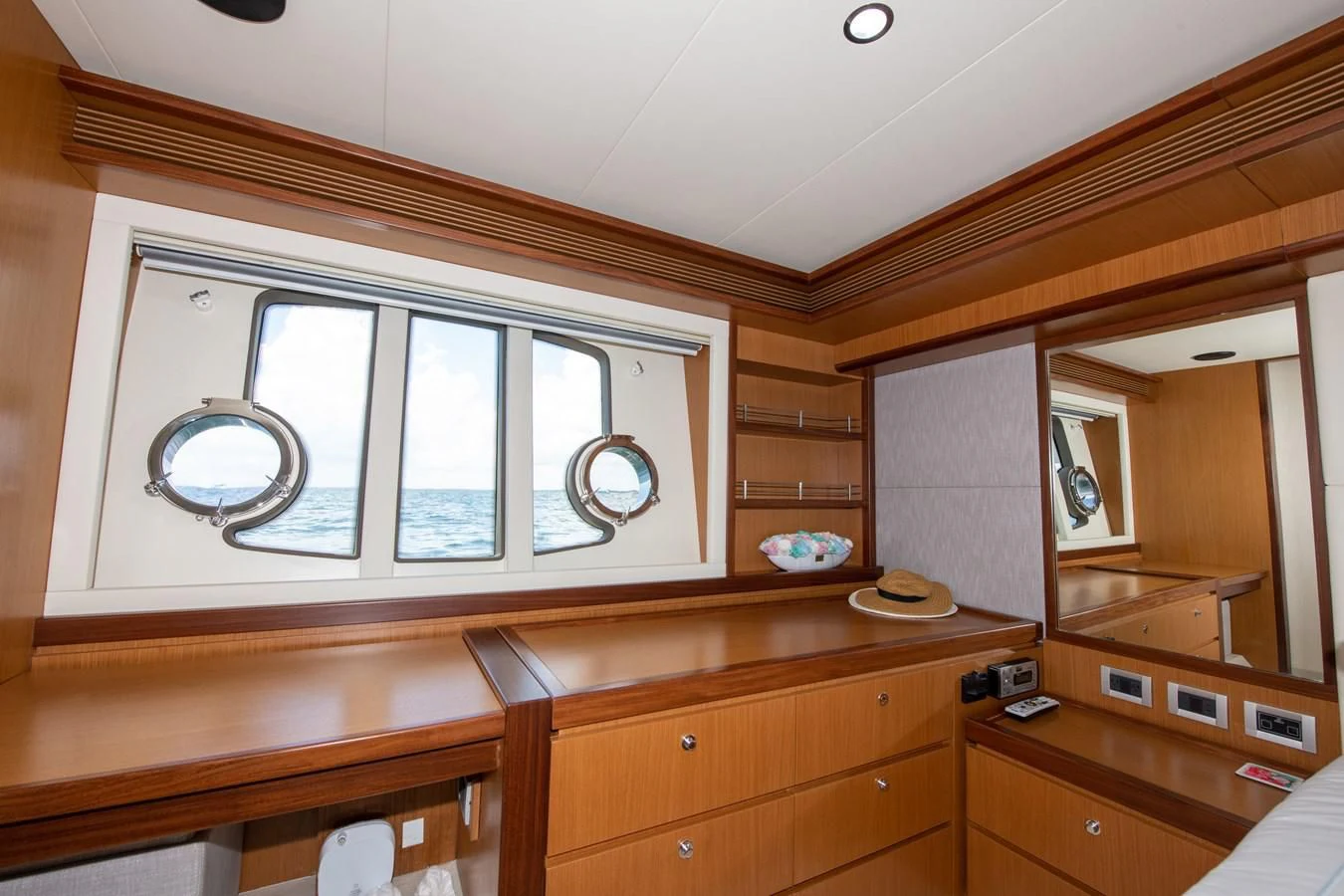 a room with a mirror and cabinets aboard HOPE Yacht for Sale
