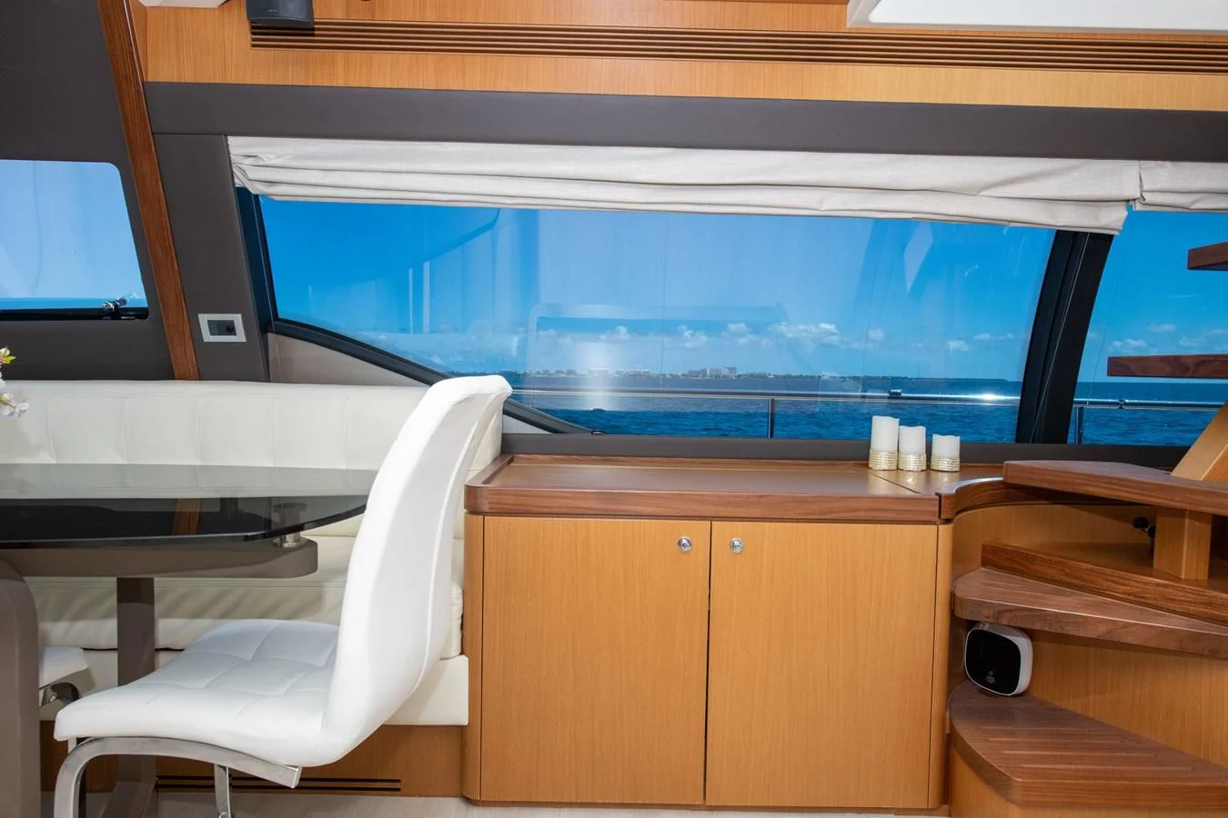 a room with a view of the water and the city below aboard HOPE Yacht for Sale