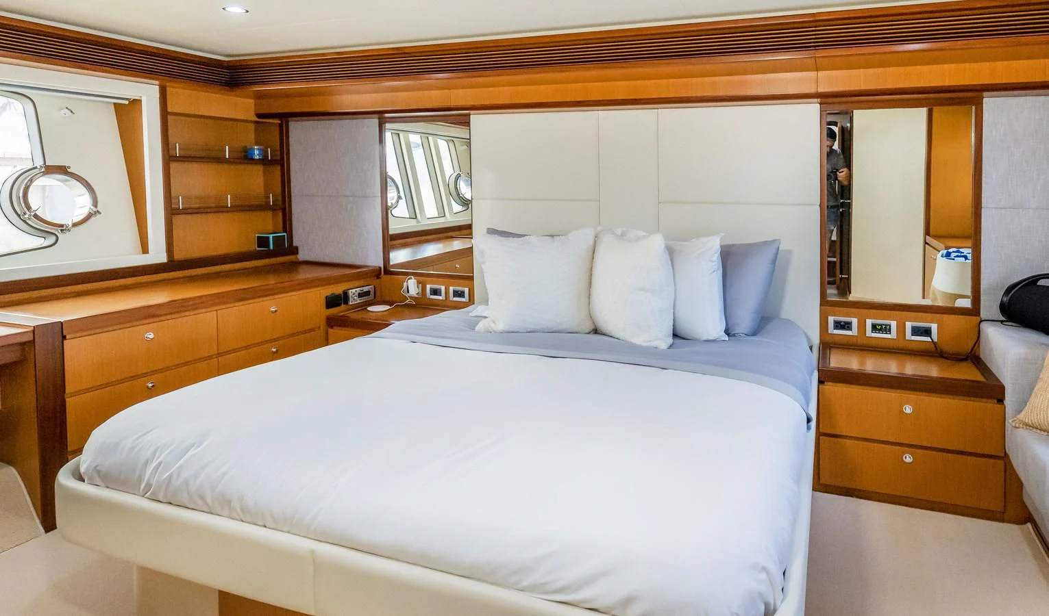 a room with a bed and a mirror aboard HOPE Yacht for Sale