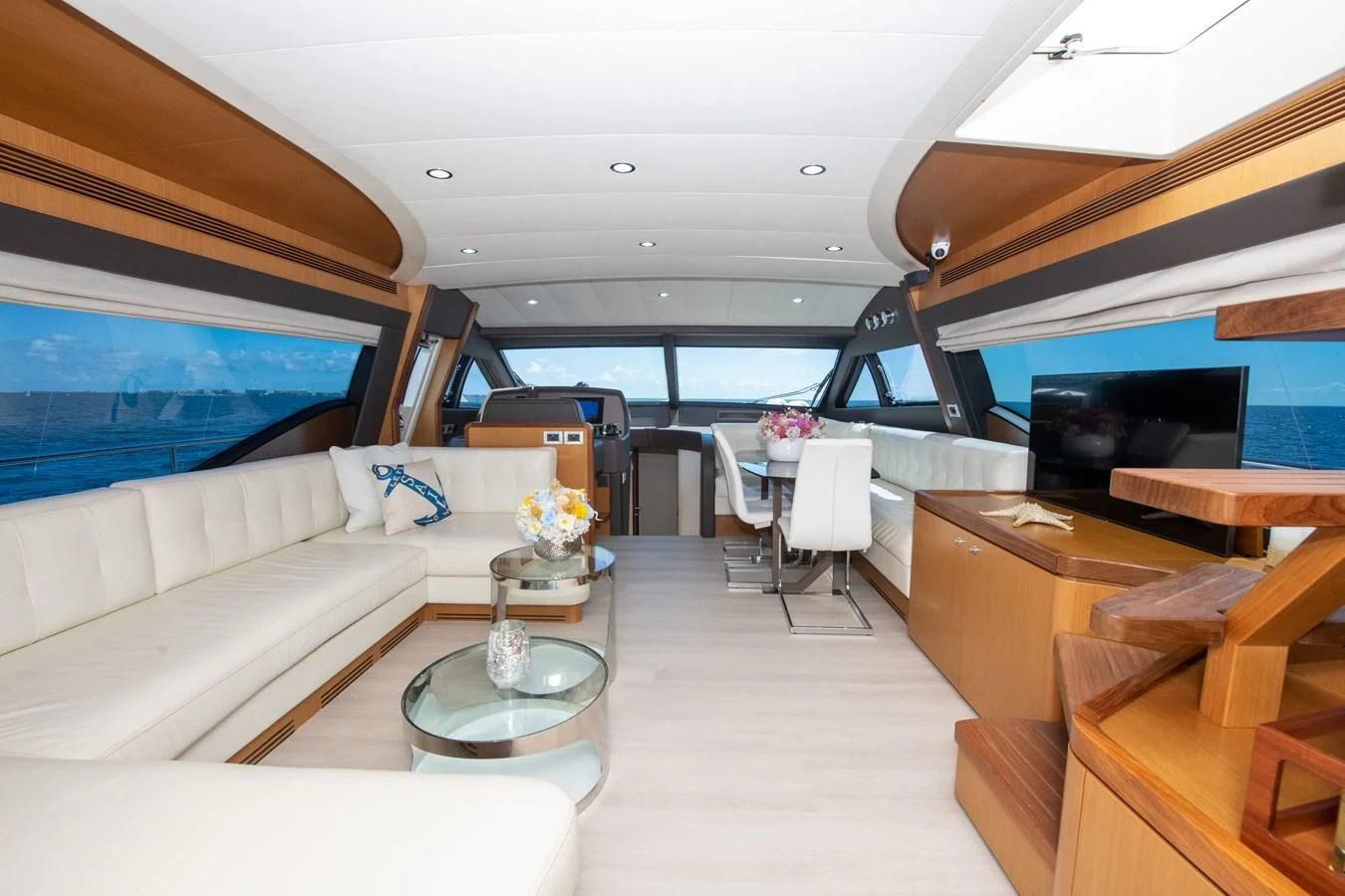 a room with a couch and a table and chairs aboard HOPE Yacht for Sale