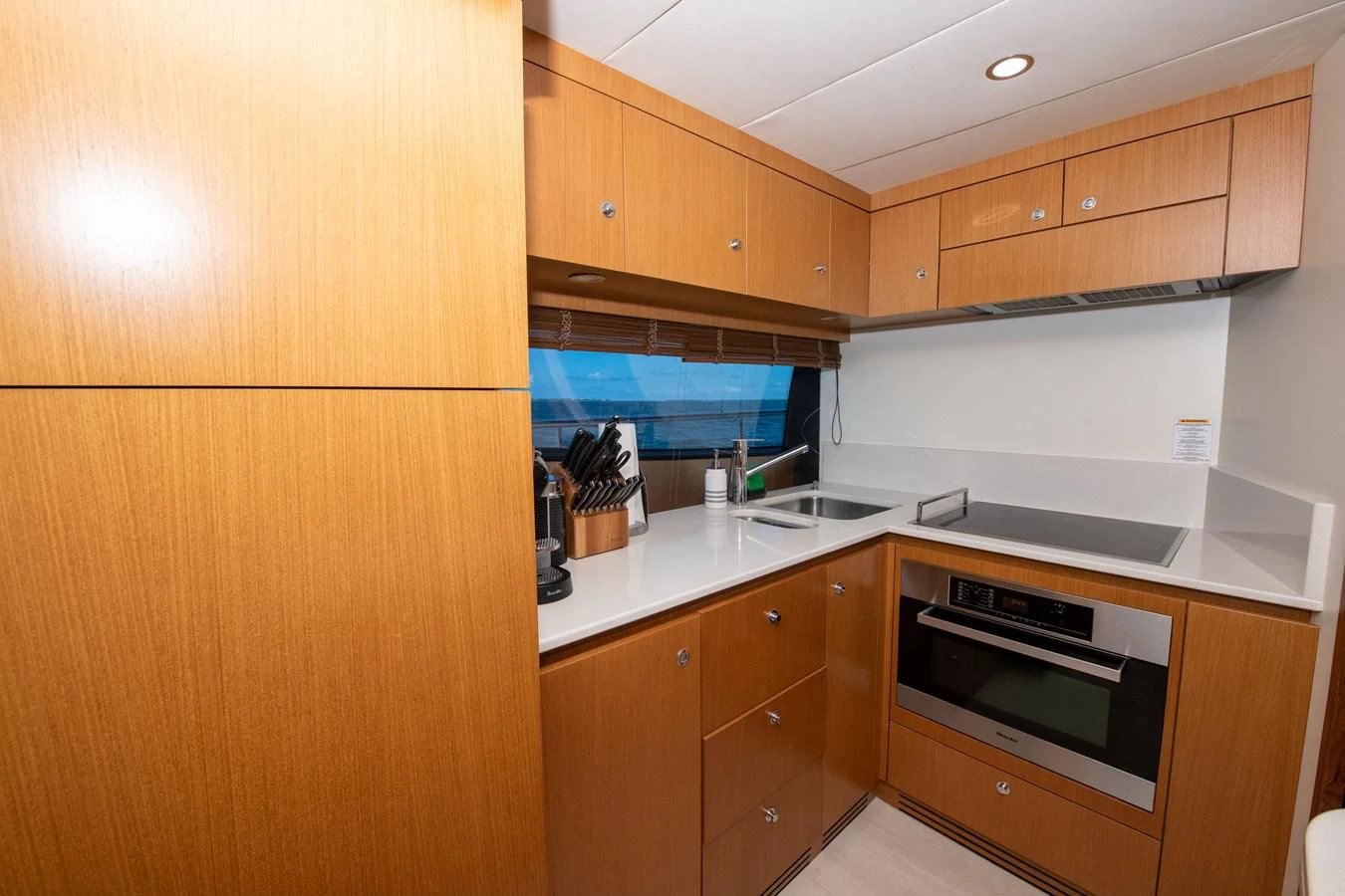 a kitchen with wooden cabinets aboard HOPE Yacht for Sale