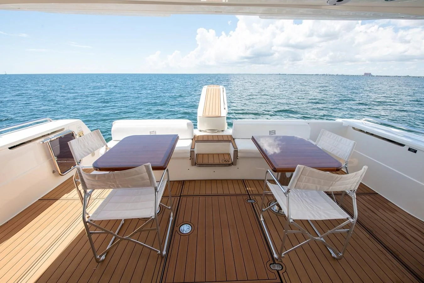 a deck with chairs and a body of water aboard HOPE Yacht for Sale