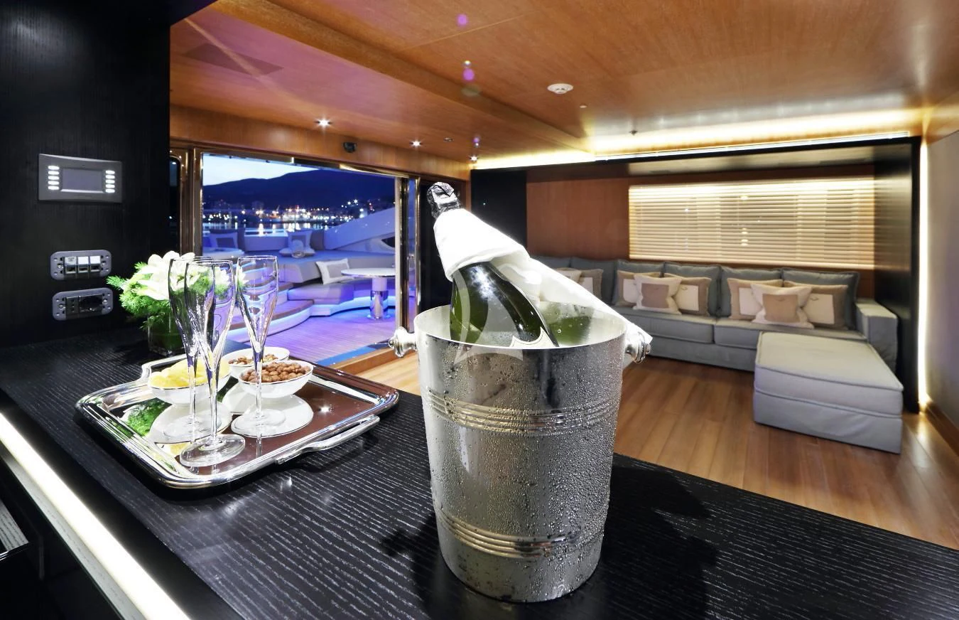 a glass of liquid on a table aboard BEATRIX Yacht for Sale