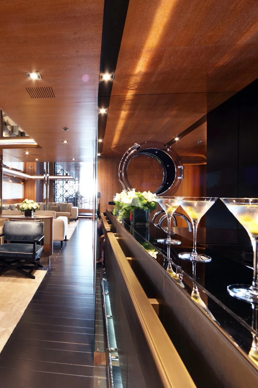 a room with a large mirror and a table with chairs aboard BEATRIX Yacht for Sale