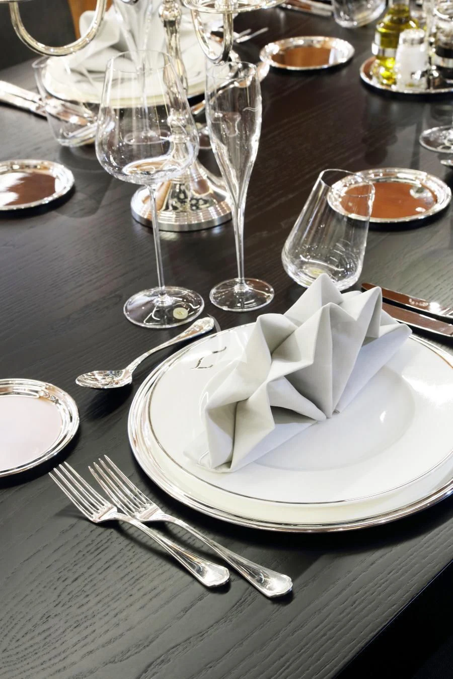a table with plates and silverware aboard BEATRIX Yacht for Sale