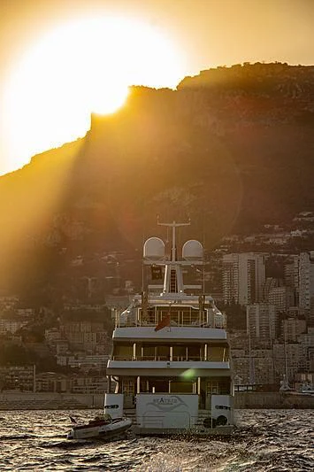 a building with a large tower in front of a large fire aboard BEATRIX Yacht for Sale