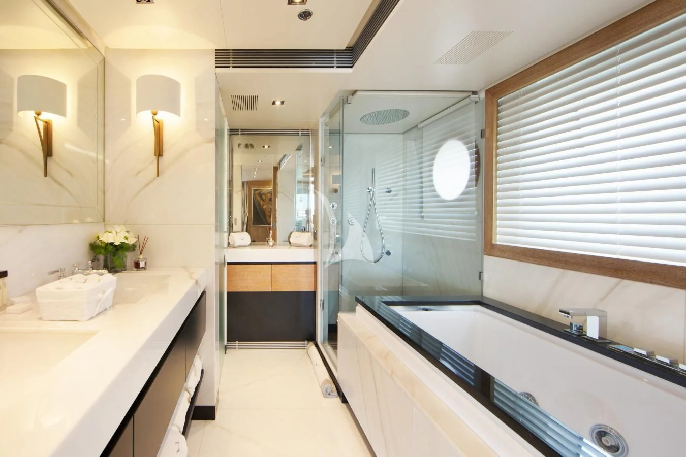 a bathroom with a tub sink and a shower unit aboard BEATRIX Yacht for Sale