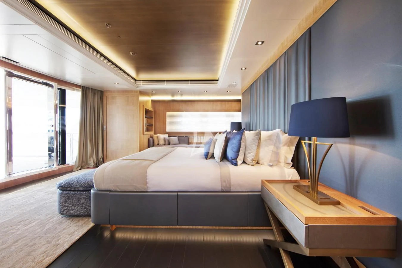 a bedroom with a bed and a lamp aboard BEATRIX Yacht for Sale