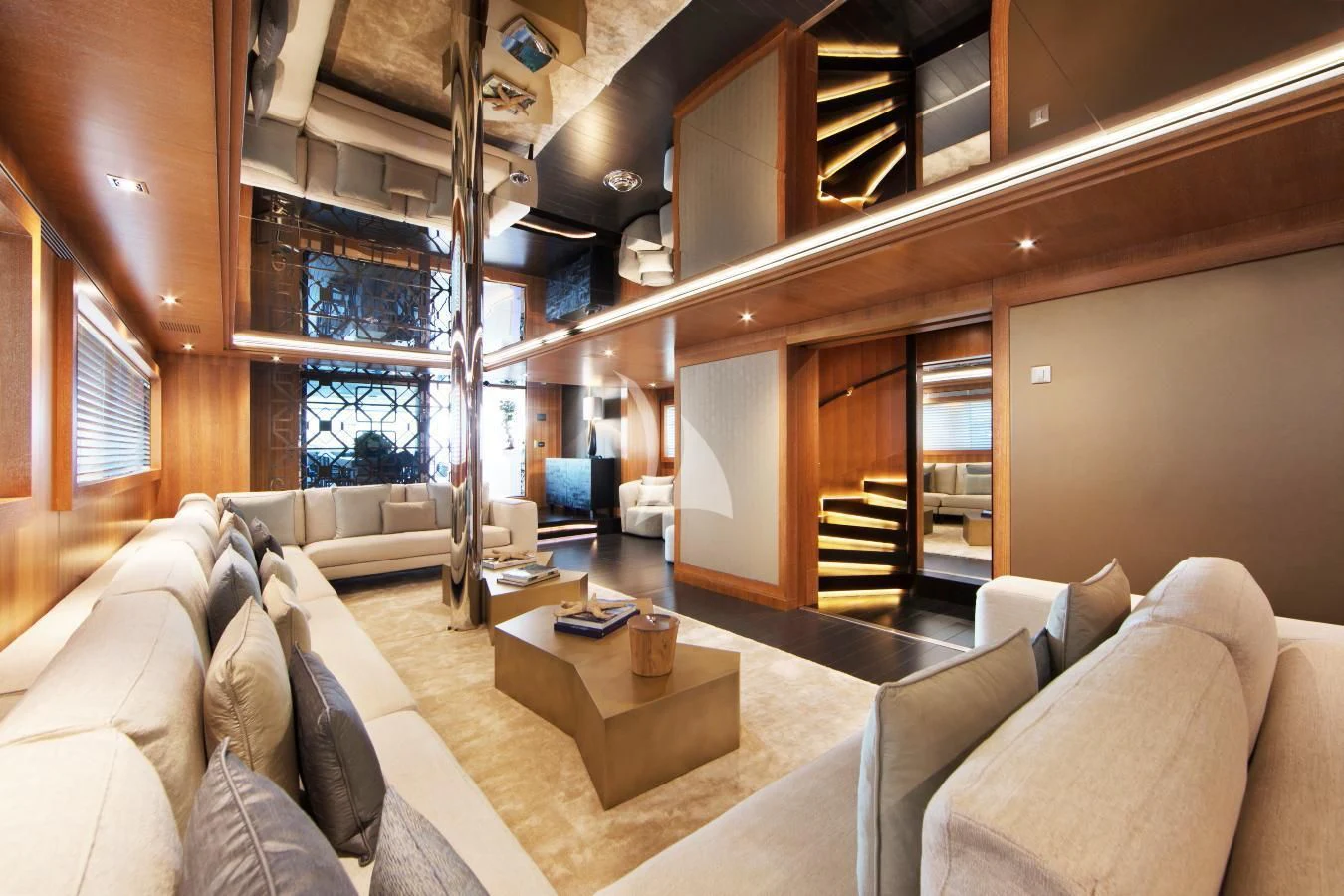 a living room with a staircase and couches aboard BEATRIX Yacht for Sale