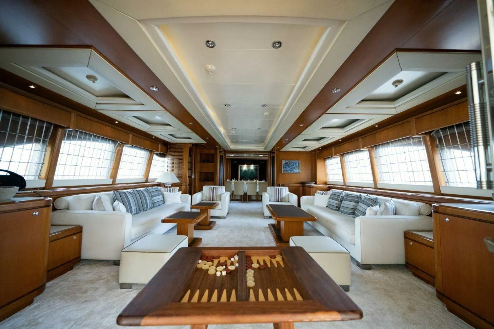 a large room with a couch and a wood table aboard ARIELA Yacht for Sale