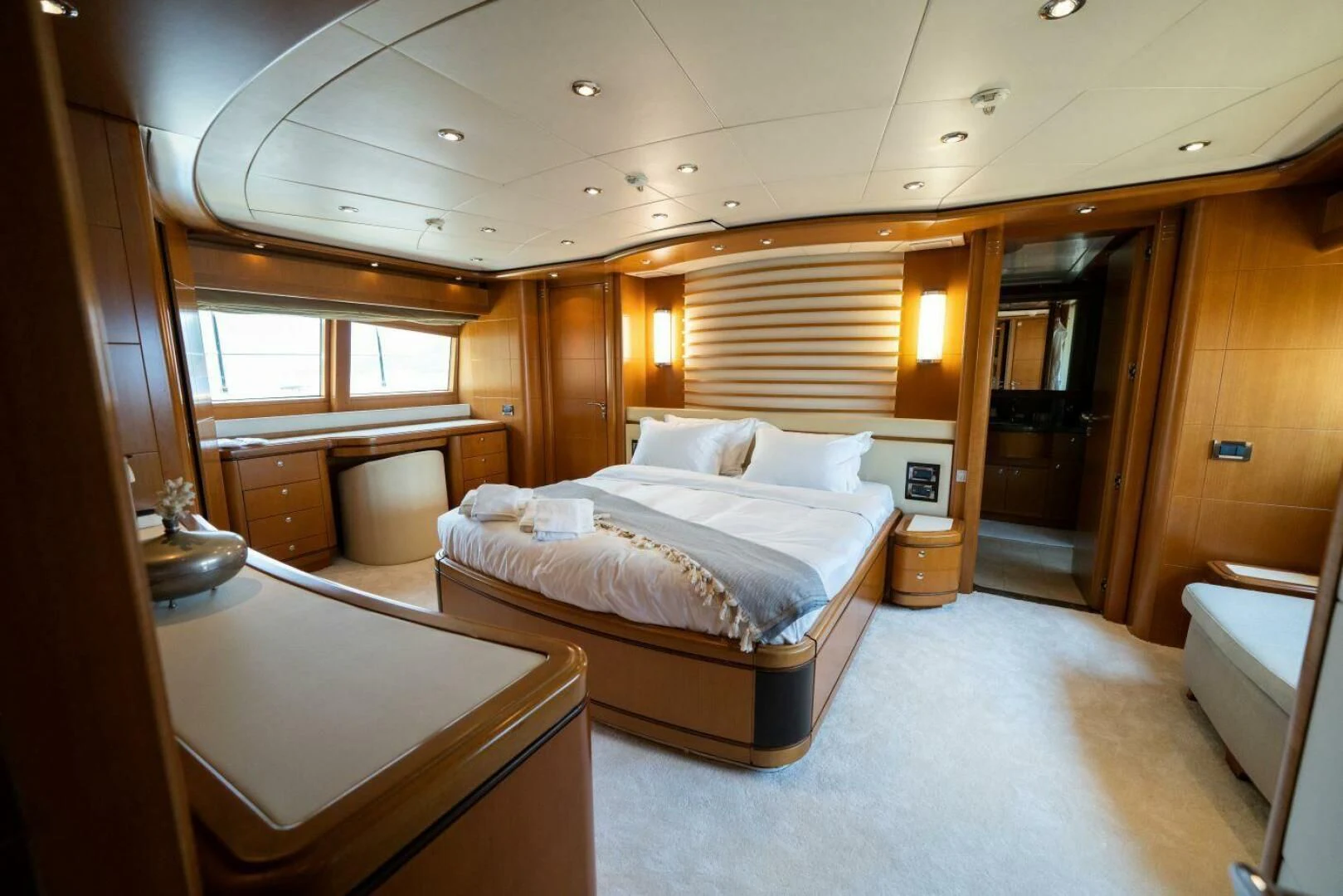 a bedroom with a bed and a desk aboard ARIELA Yacht for Sale