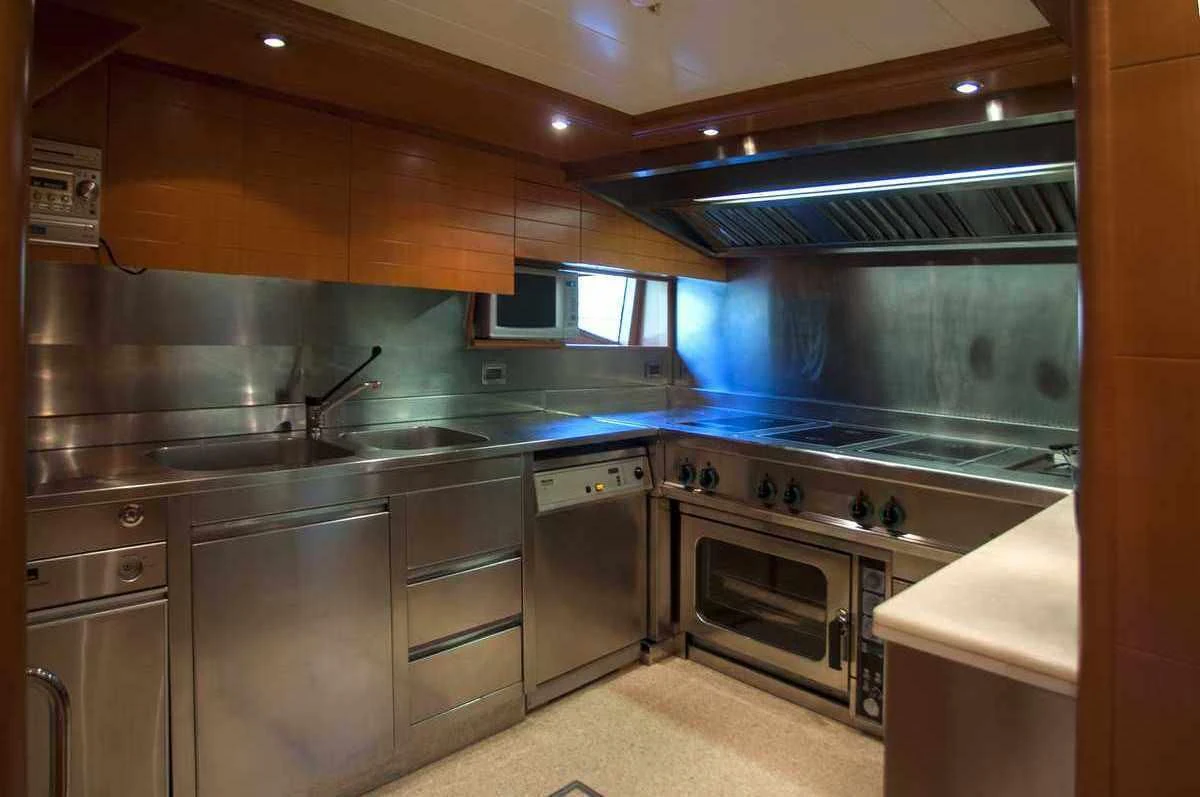 a kitchen with stainless steel appliances aboard ARIELA Yacht for Sale