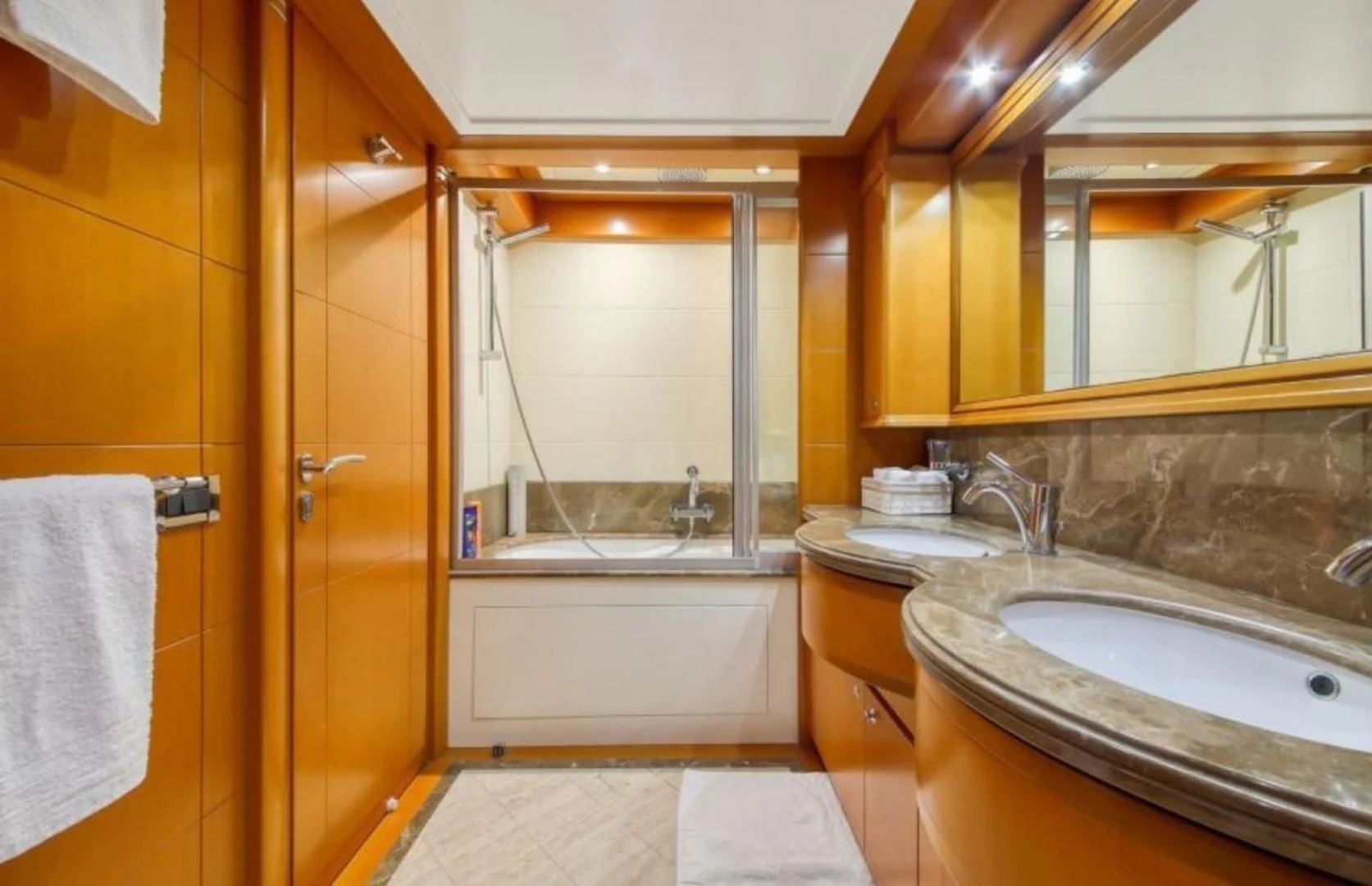 a bathroom with a sink and a bathtub aboard ARIELA Yacht for Sale