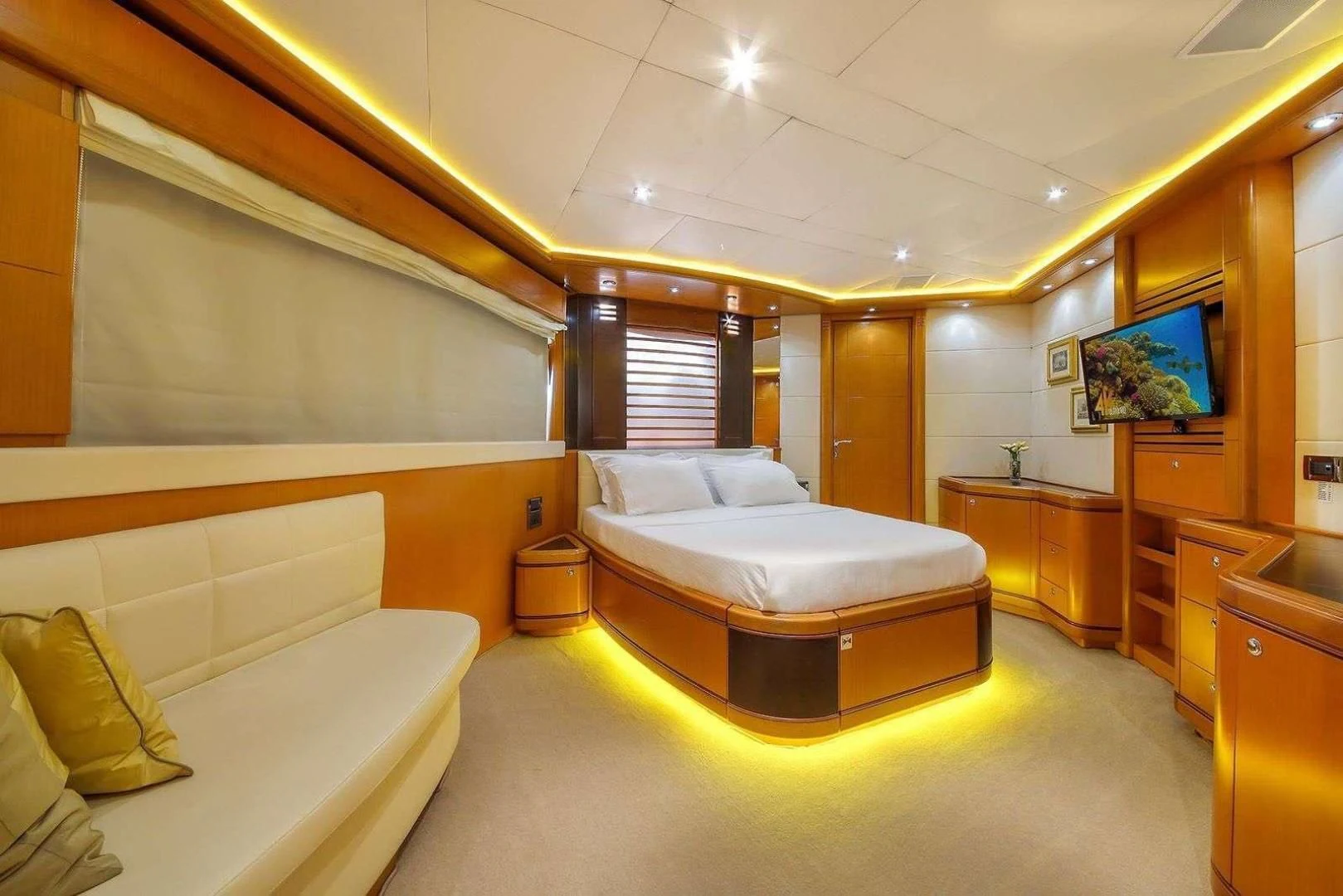 a room with a bed and a tv on the wall aboard ARIELA Yacht for Sale