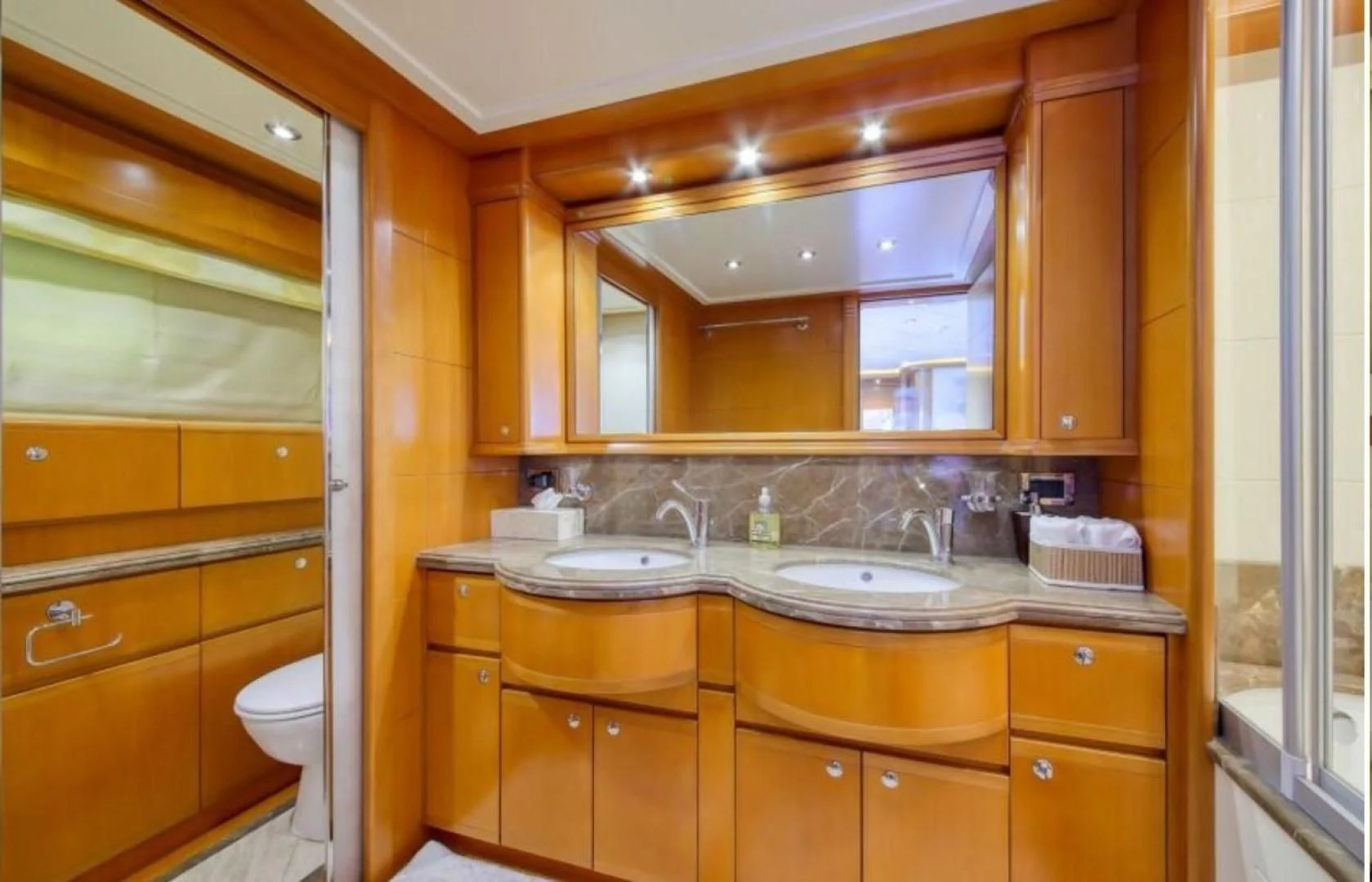 a bathroom with a large mirror aboard ARIELA Yacht for Sale