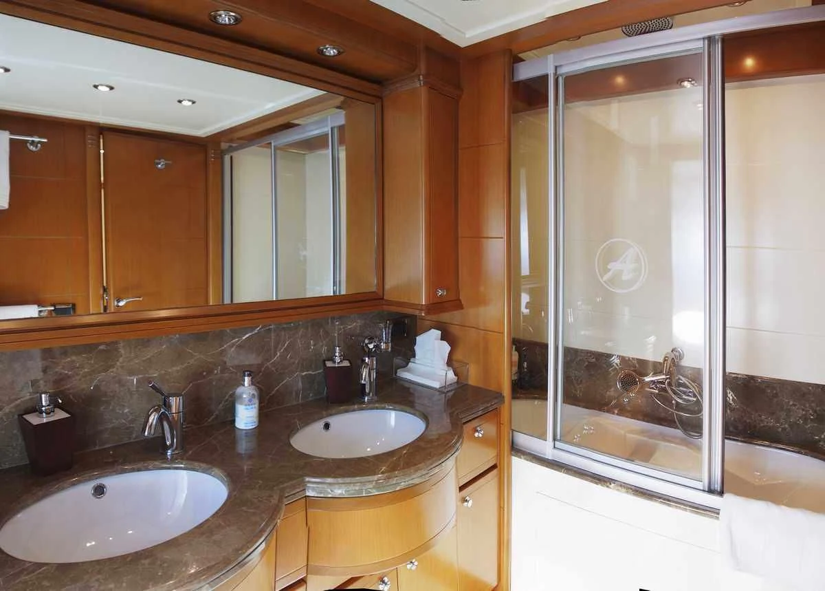a bathroom with a sink and a shower aboard ARIELA Yacht for Sale