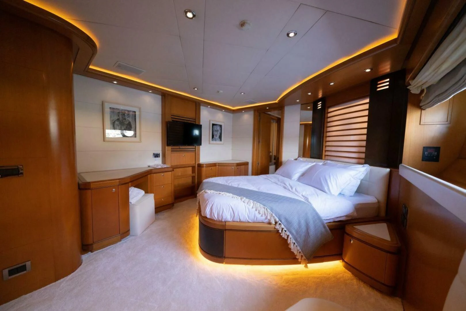 a room with a bed and a television aboard ARIELA Yacht for Sale