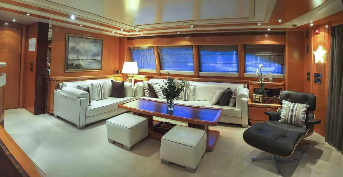 a living room with a table and chairs aboard ARIELA Yacht for Sale