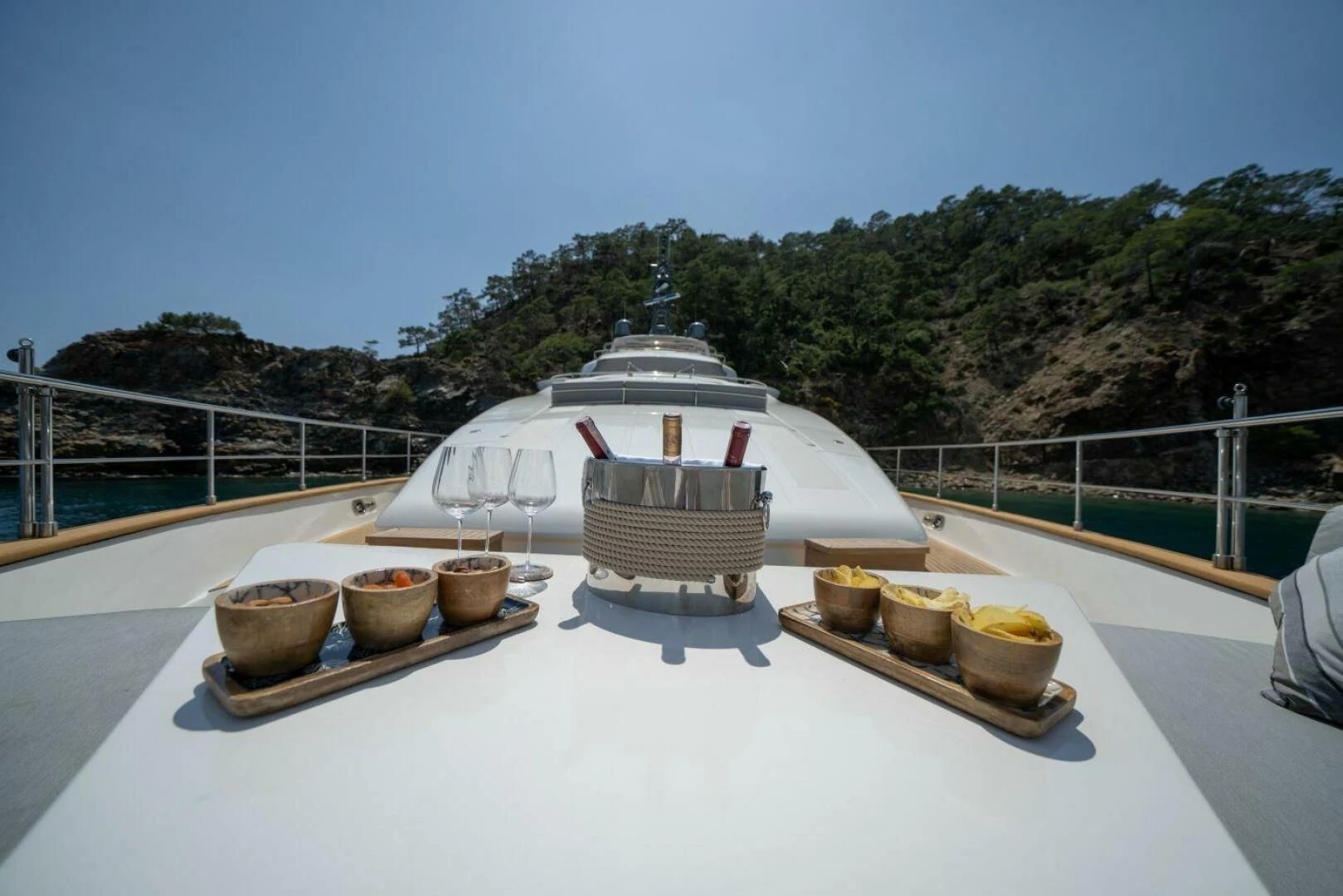 a white table with bowls and plates on it aboard ARIELA Yacht for Sale