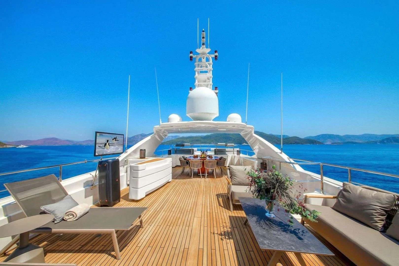 a deck with a large ship on it and a large tower in the background aboard ARIELA Yacht for Sale