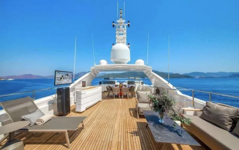 a large white ship with a tower on a dock aboard ARIELA Yacht for Sale