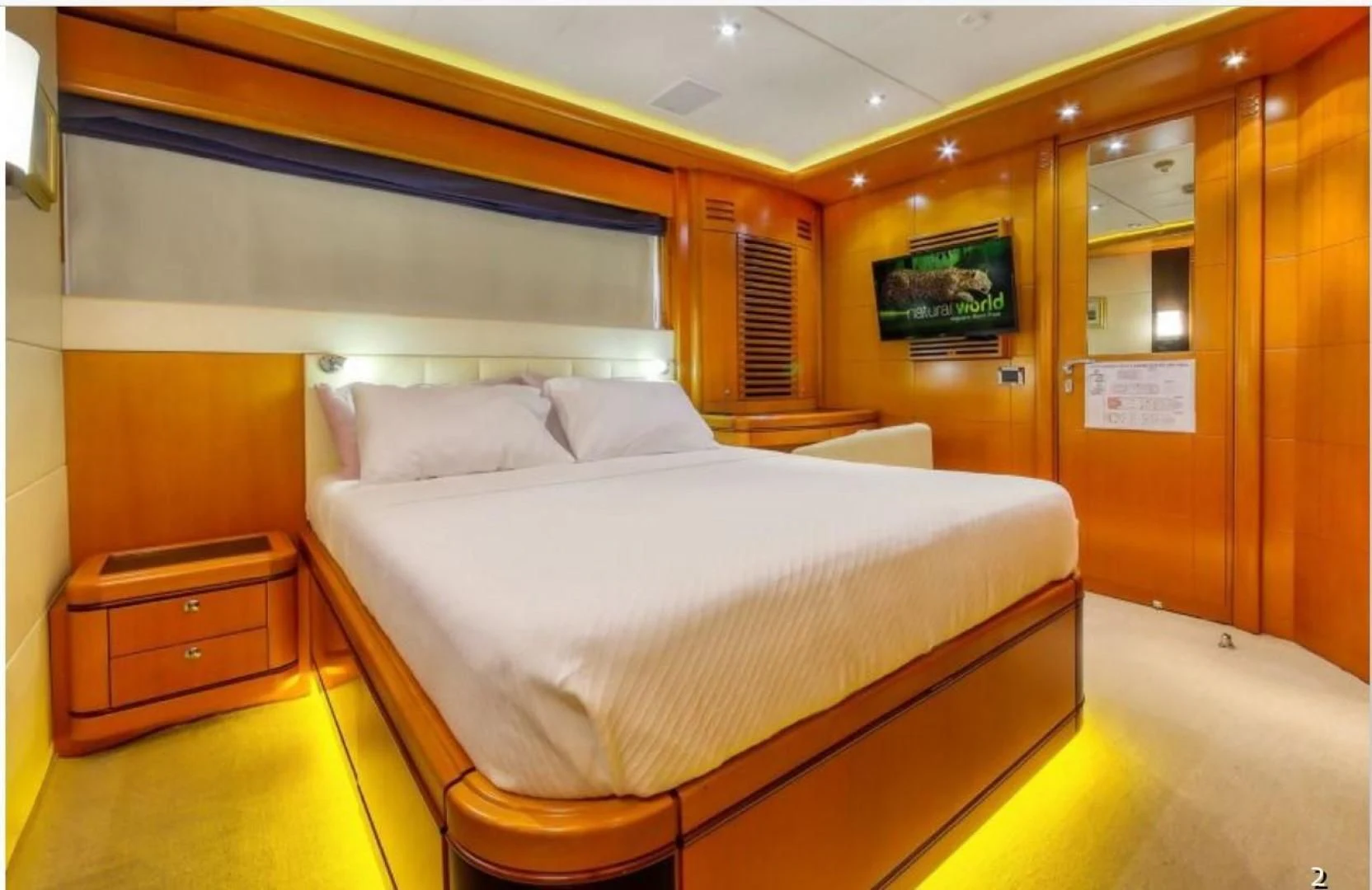 a room with a bed and a desk aboard ARIELA Yacht for Sale