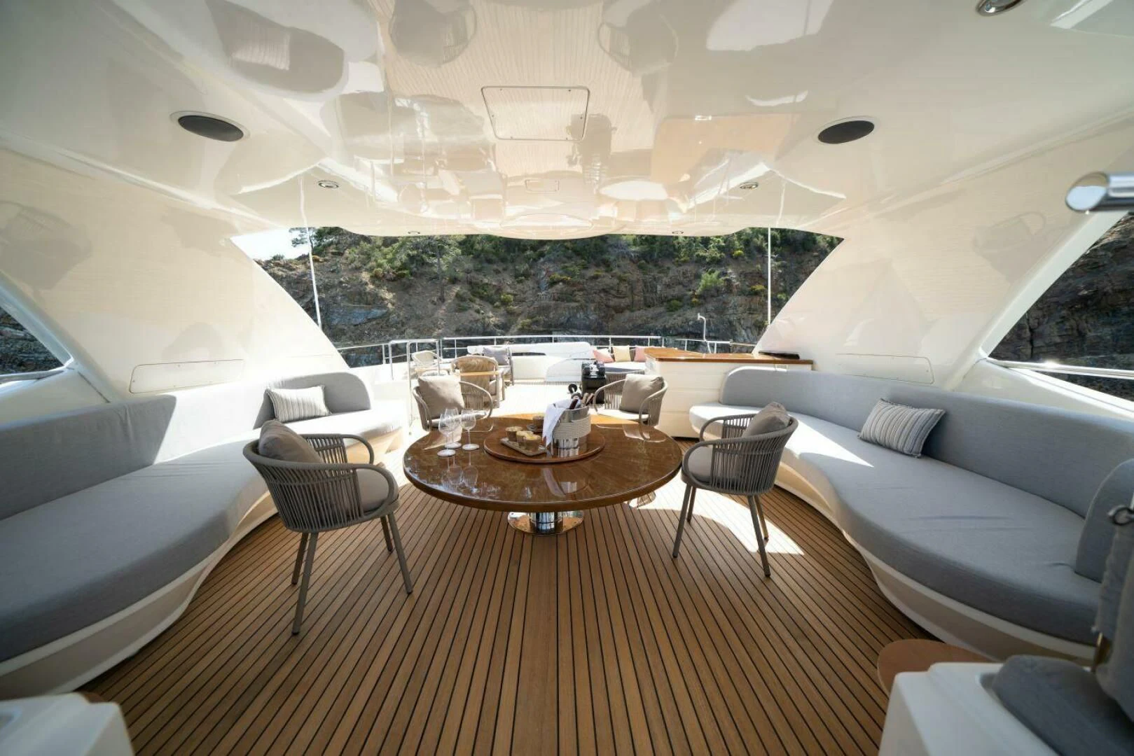 a room with a table chairs and a couch aboard ARIELA Yacht for Sale