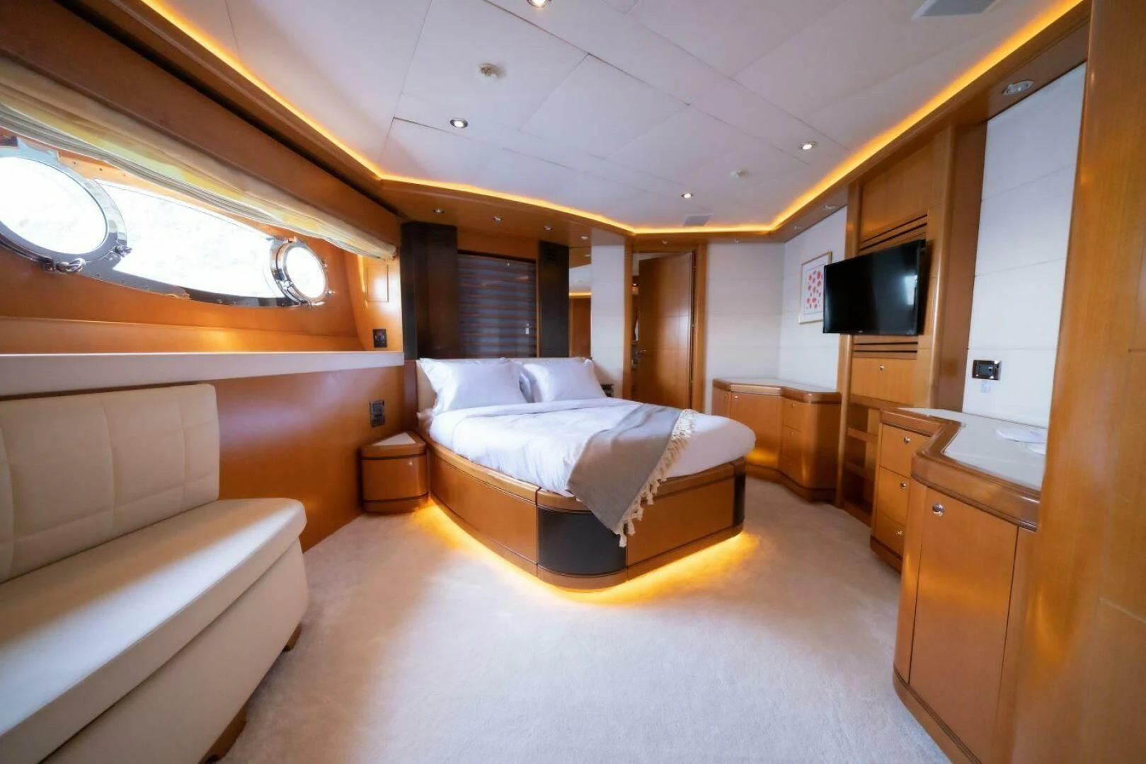 a bedroom with a bed and a tv aboard ARIELA Yacht for Sale