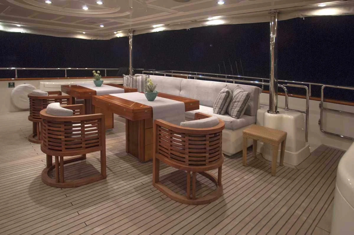 a room with a table chairs and a couch aboard ARIELA Yacht for Sale