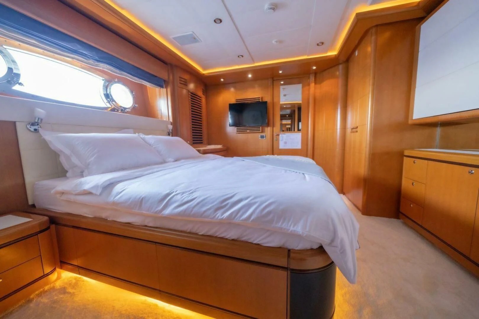 a bed with white sheets aboard ARIELA Yacht for Sale