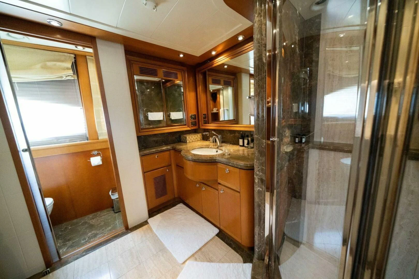 a bathroom with a glass shower aboard ARIELA Yacht for Sale