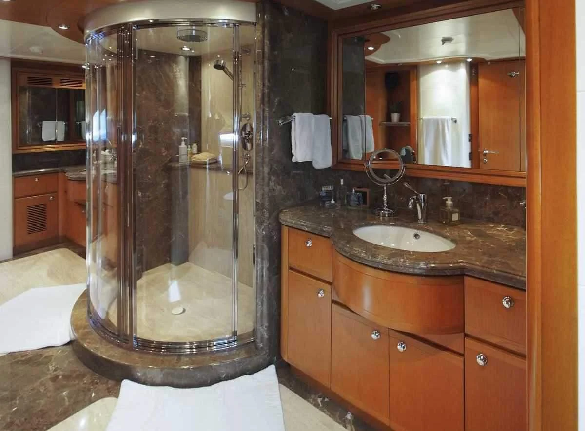 a bathroom with a glass shower aboard ARIELA Yacht for Sale