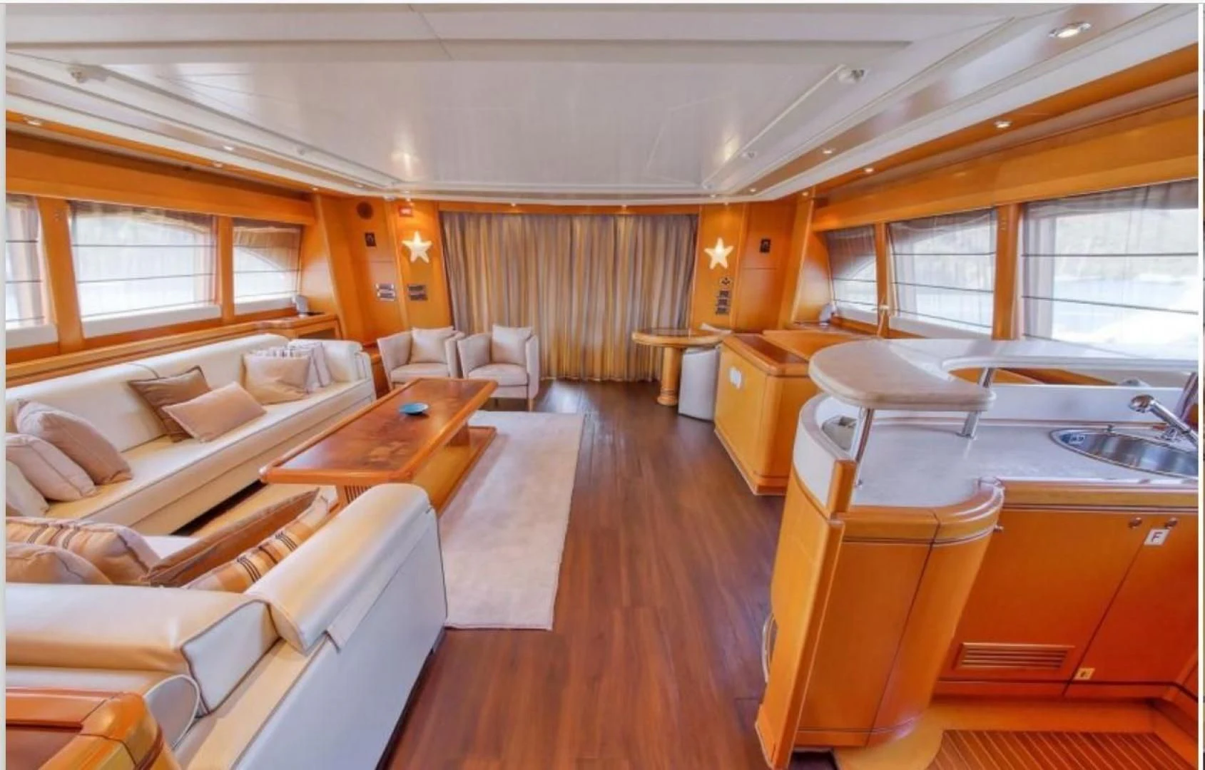 a large room with a large bed and a table aboard ARIELA Yacht for Sale