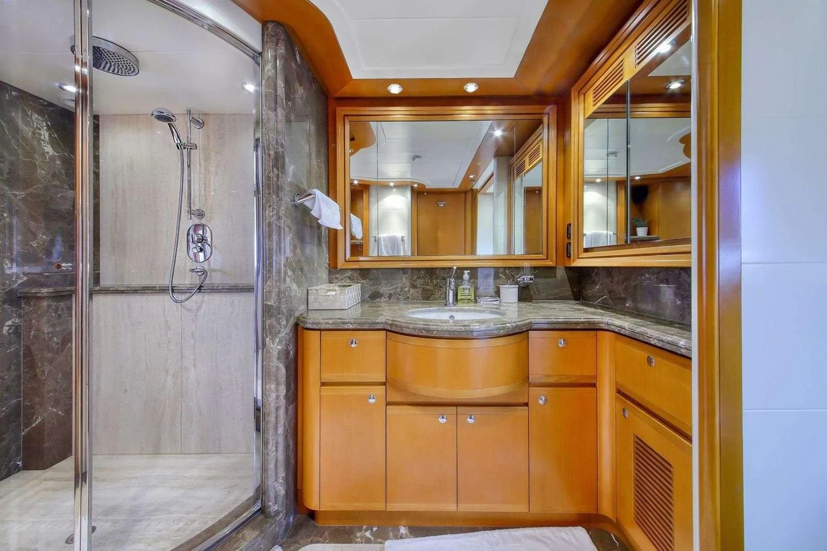 a kitchen with wooden cabinets aboard ARIELA Yacht for Sale
