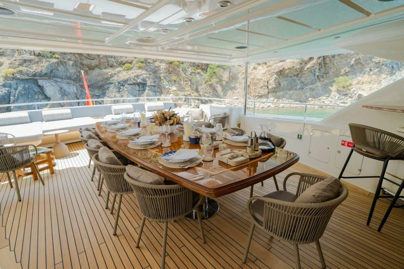 a table set for a meal on a deck aboard ARIELA Yacht for Sale