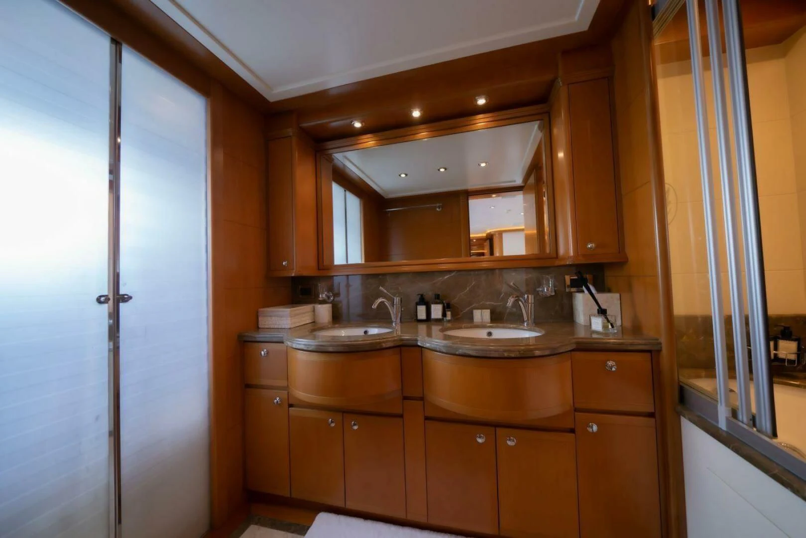 a bathroom with wooden cabinets aboard ARIELA Yacht for Sale