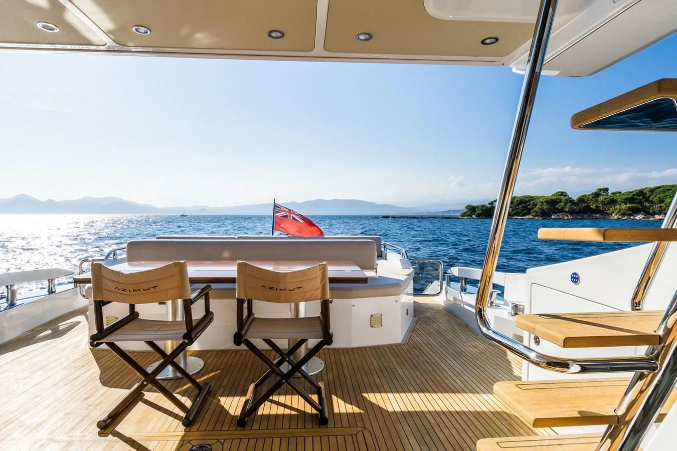 a table and chairs on a deck overlooking a body of water aboard YACHTI ANA Yacht for Sale