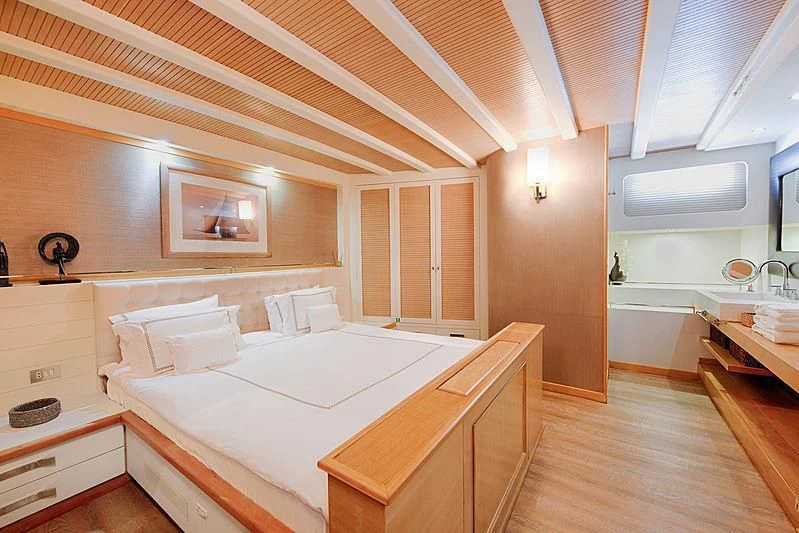 a room with a bed and a sink aboard COBRA KING Yacht for Sale