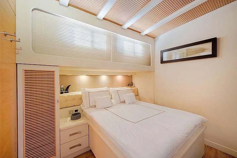 a room with a bed and a closet aboard COBRA KING Yacht for Sale