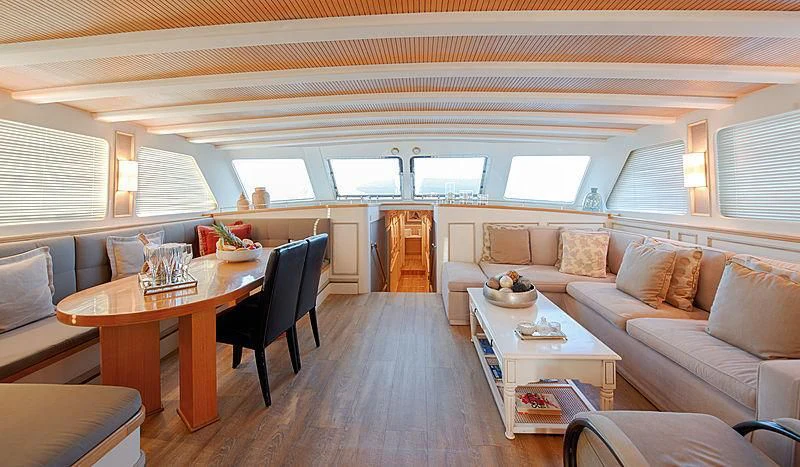 a living room with a couch and a table aboard COBRA KING Yacht for Sale