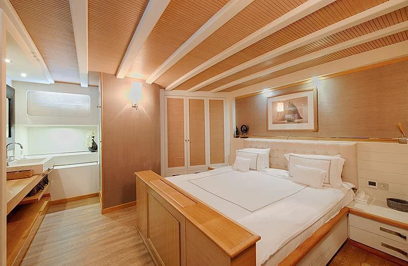 a room with a bed and a table aboard COBRA KING Yacht for Sale