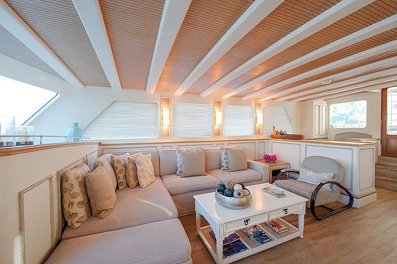 a living room with a couch and a table aboard COBRA KING Yacht for Sale