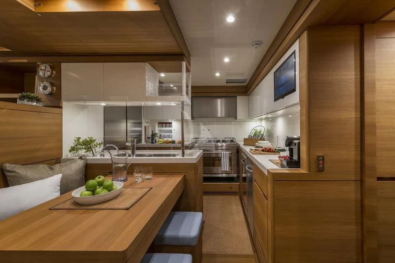 a kitchen with a table and a couch aboard FARFALLA Yacht for Sale