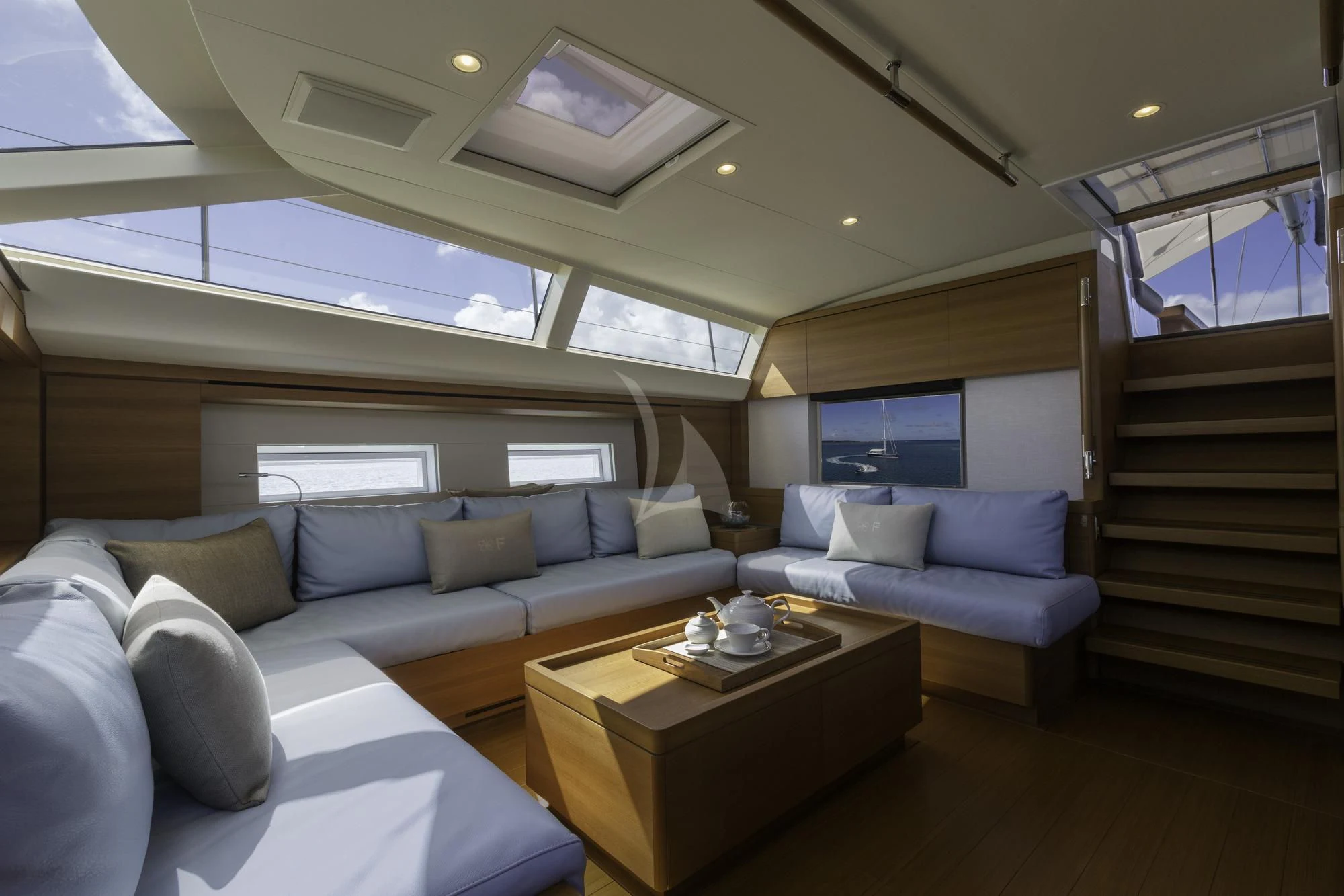a living room with a couch and a coffee table aboard FARFALLA Yacht for Sale