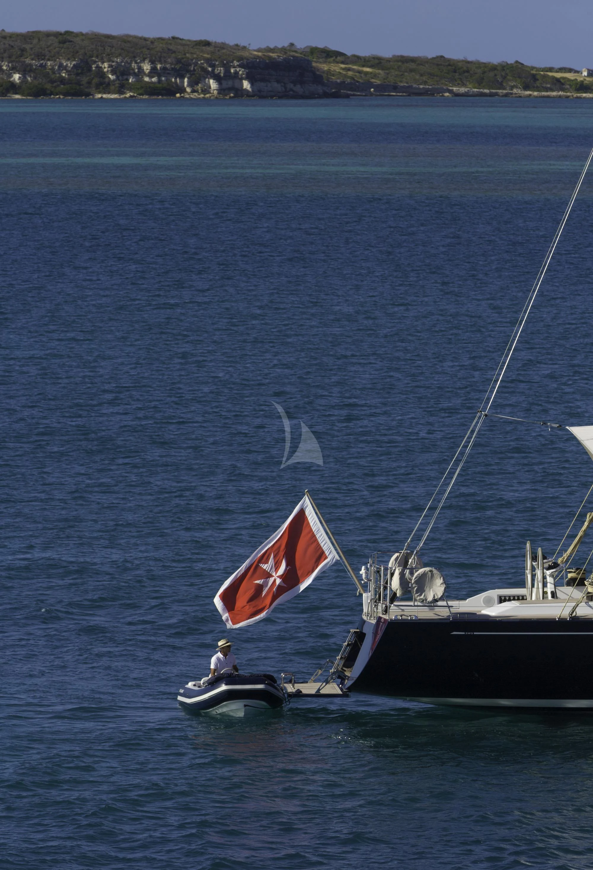 a sailboat with a flag aboard FARFALLA Yacht for Sale
